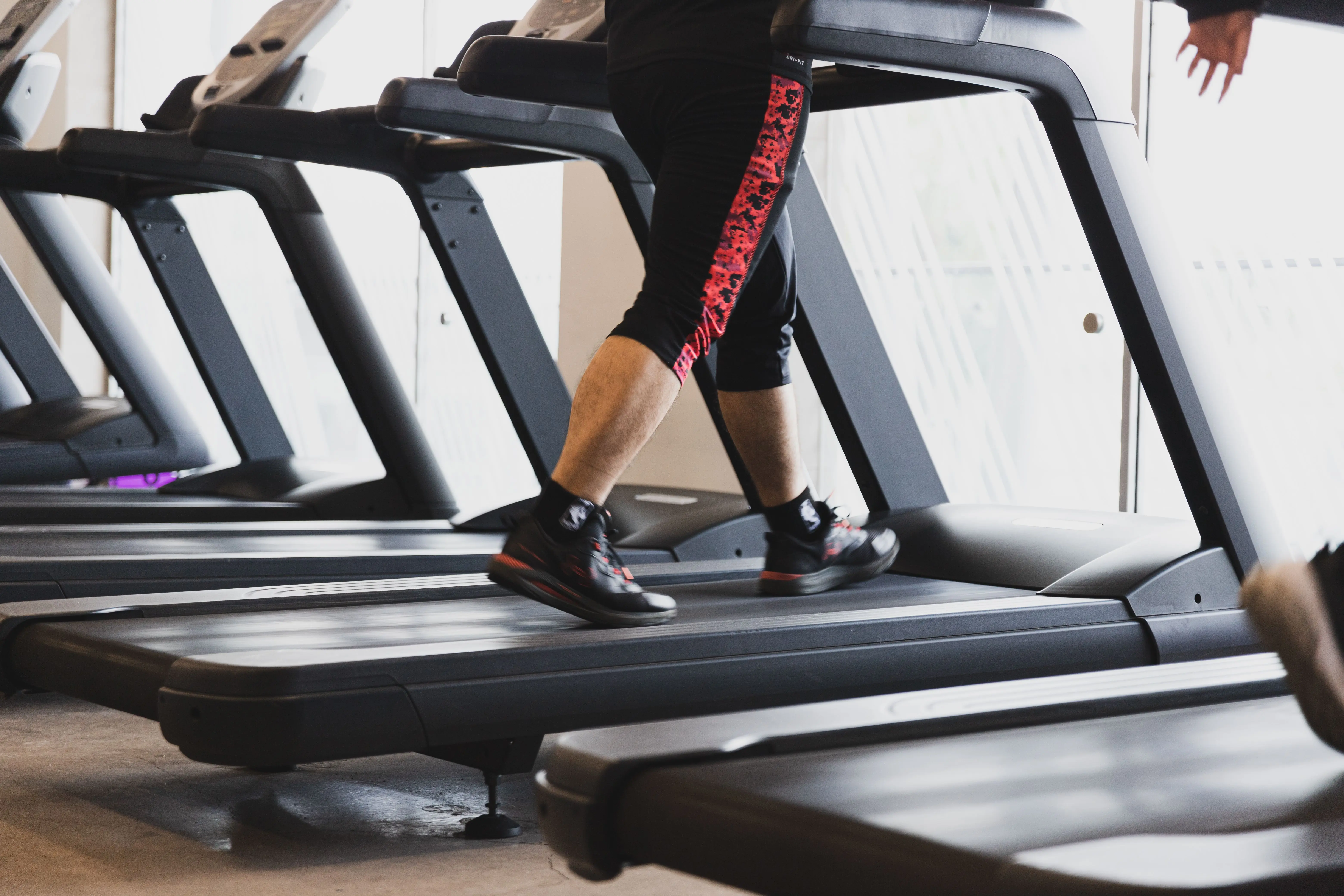 A runner mid-stride on a Technogym treadmill