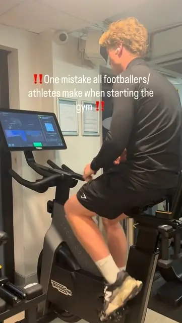 A member on an exercise bike with a tip for footballers starting at the gym