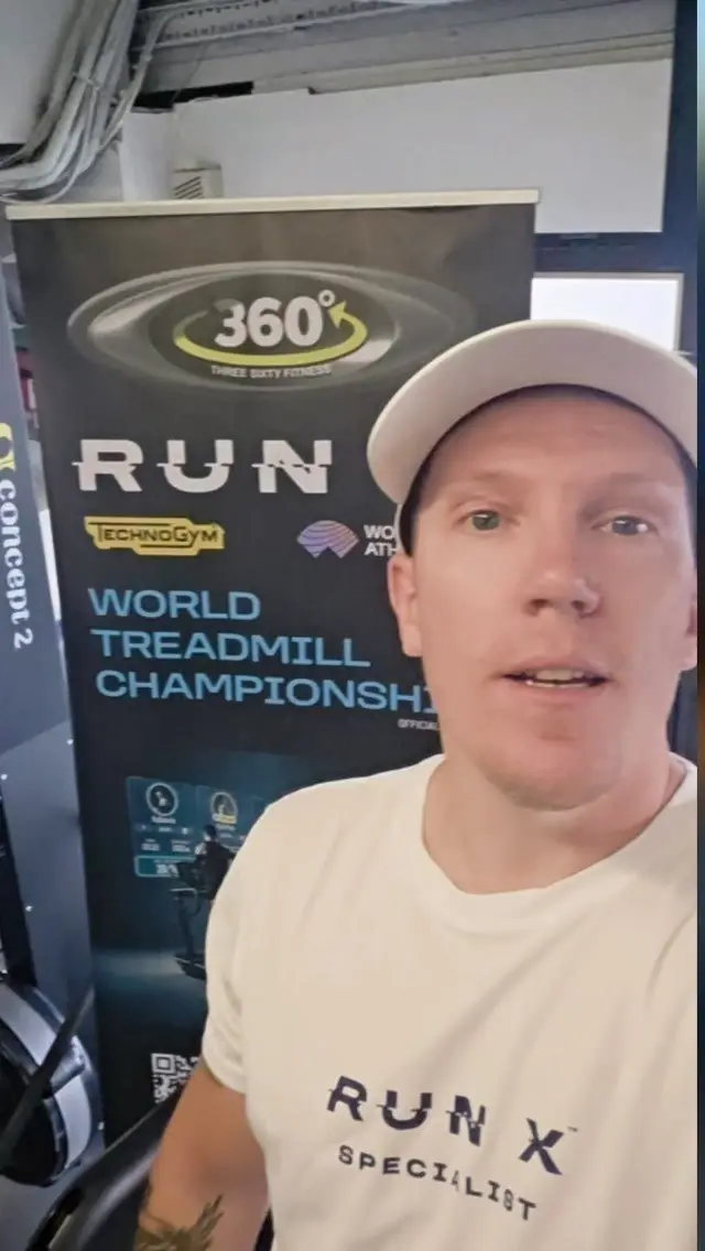 John, the gym's RUN X specialist, talking to camera beside a RUN X banner